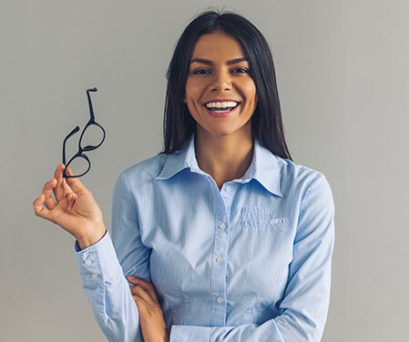 Young Woman Holding eyeglasses