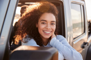 smiling woman sitting in car