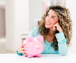 woman sitting with piggy bank