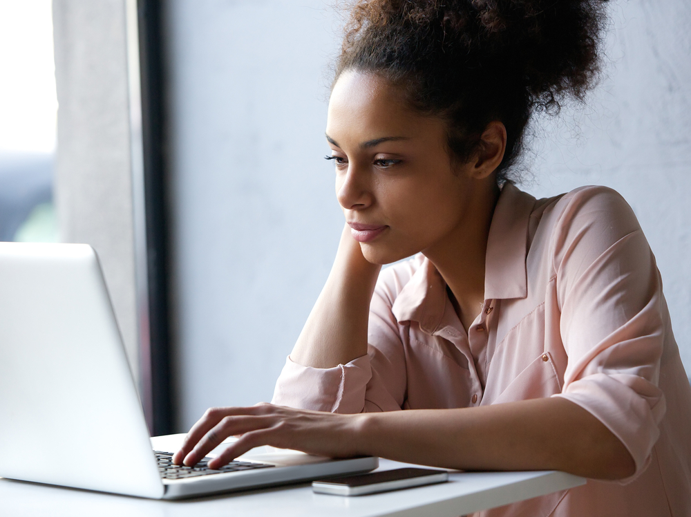 Young woman looking at a laptop