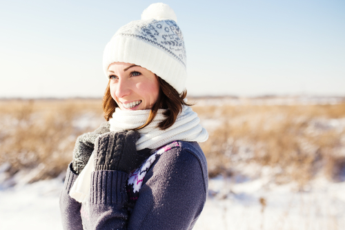 Young woman smiling outside after LASIK