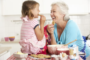 grandmother enjoying cookies with her granddaughter