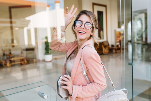 Young woman with eyeglasses smiling before LASIK eye surgery